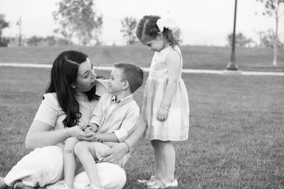 A black and white photo of a mother, son, and daughter.