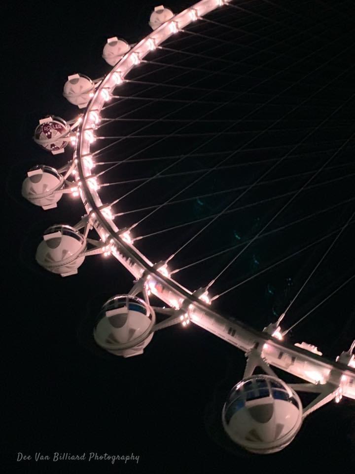 The Link Hotel's ferris wheel lit up at night.