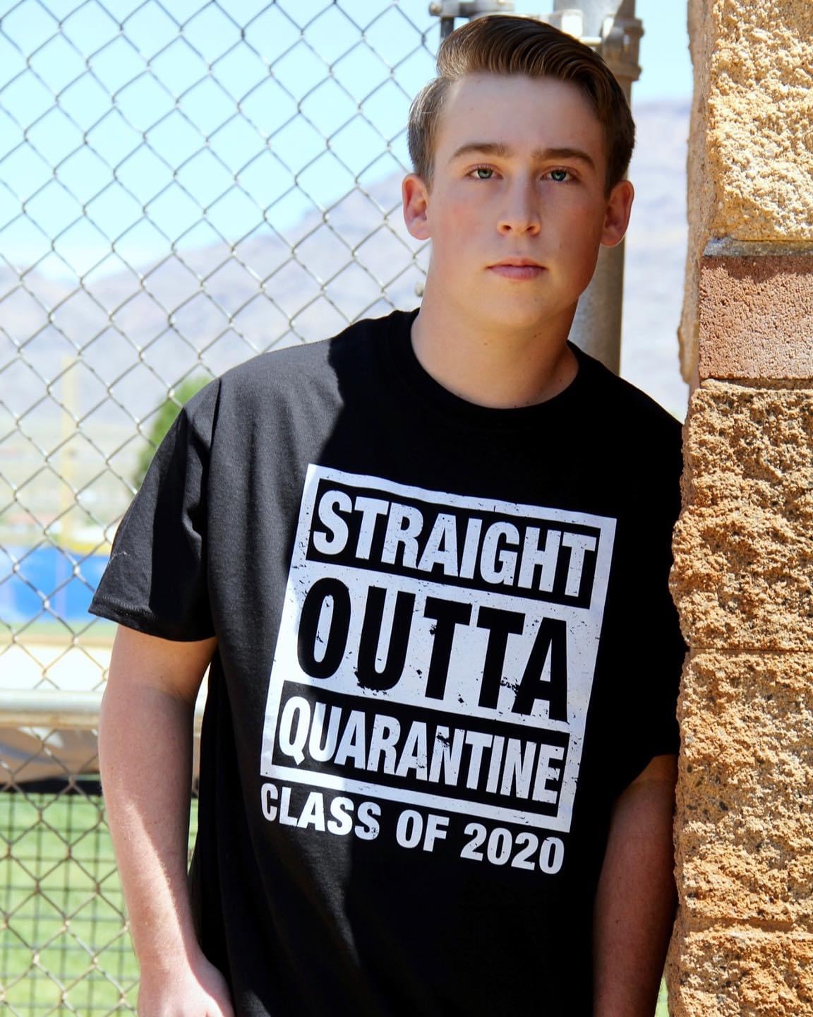 A young man poses with a t-shirt that says: Straight Outta Quarantine, Class of 2020.